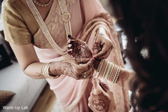 Indian bride getting her Hath Panja bracelet on. Indian bride getting her Hath Panja bracelet on.
