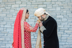 Indian groom kissing the bride's hand Indian groom kissing the bride's hand
