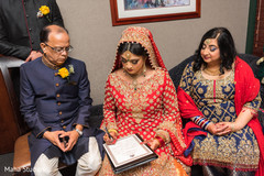 Adorable indian bride signing wedding contract Adorable indian bride signing wedding contract