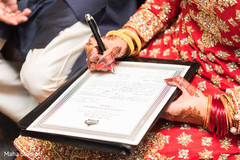 Indian bride signing wedding contract Indian bride signing wedding contract