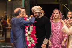 Indian groom receiving garland Indian groom receiving garland