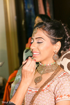 Enchanting maharani being assisted by the makeup artist Enchanting maharani being assisted by the makeup artist