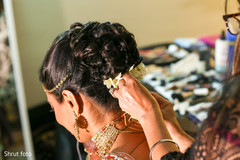 Capture of the hair and makeup artist working with the Indian bride Capture of the hair and makeup artist working with the Indian bride
