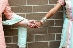 Indian bride and groom holding hands for the photo shoot Indian bride and groom holding hands for the photo shoot