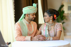 Indian couple looking at each other while photo shoot happens Indian couple looking at each other while photo shoot happens