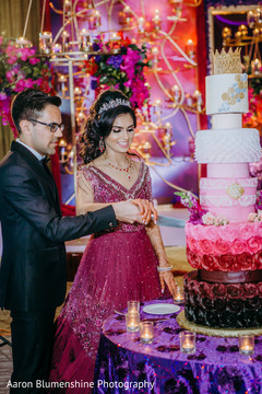 Indian newlyweds cutting the cake Indian newlyweds cutting the cake