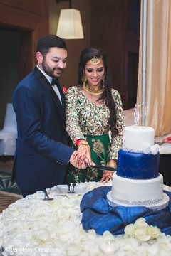 Indian newlyweds cut the wedding cake during the reception Indian newlyweds cut the wedding cake during the reception