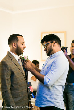 Indian groom being assisted prior to the wedding Indian groom being assisted prior to the wedding