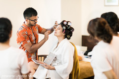 Beautiful maharani being assisted by the makeup artist Beautiful maharani being assisted by the makeup artist
