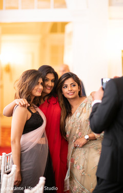 Guests pose for pictures at the Indian wedding ceremony Guests pose for pictures at the Indian wedding ceremony