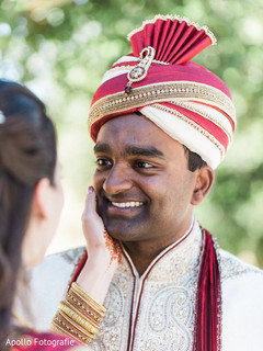 Indian groom staring at his beautiful wife during the photo shoot Indian groom staring at his beautiful wife during the photo shoot