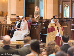 Indian Catholic wedding priest at wedding ceremony. Indian Catholic wedding priest at wedding ceremony.
