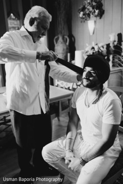 Stunning capture of the Indian groom being aided with his Pagri Stunning capture of the Indian groom being aided with his Pagri