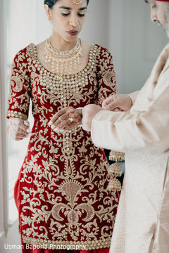 Stunning maharani is aided by a family member instants before the Indian ceremony Stunning maharani is aided by a family member instants before the Indian ceremony