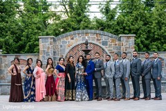 Indian newlyweds posing with their bridal party Indian newlyweds posing with their bridal party