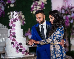 Sweet indian couple cutting their wedding cake Sweet indian couple cutting their wedding cake