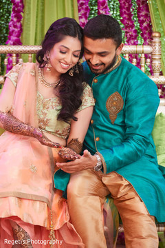 Indian groom admiring mehndi designs Indian groom admiring mehndi designs