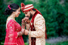 Indian groom sweetly kissing the bride's hand Indian groom sweetly kissing the bride's hand