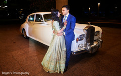 Indian couple posing next to their classic car Indian couple posing next to their classic car