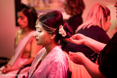 Beautiful maharani being assisted with the hair and makeup Beautiful maharani being assisted with the hair and makeup