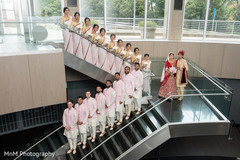 Groomsmen and bridesmaids pose with the Indian couple Groomsmen and bridesmaids pose with the Indian couple