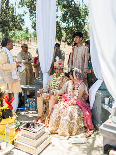 Indian bride and groom have a laugh time as the ceremony begins