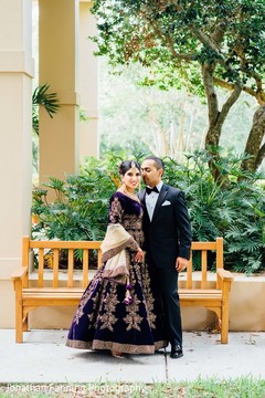 Elegant Indian bride and groom posing with their wedding reception outfits. Elegant Indian bride and groom posing with their wedding reception outfits.