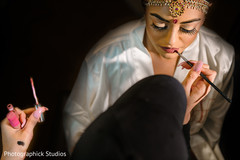 Indian bride getting her wedding makeup done. Indian bride getting her wedding makeup done.