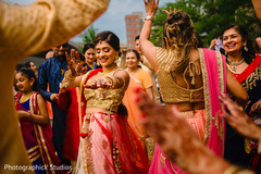 Indian bride and bridesmaids dancing at the baraat celebration. Indian bride and bridesmaids dancing at the baraat celebration.