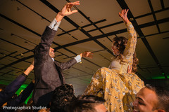 Joyful Indian bride and groom at a dance performance capture. Joyful Indian bride and groom at a dance performance capture.