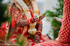 Indian couple holding items during wedding ceremony ritual. Indian couple holding items during wedding ceremony ritual.