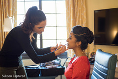 Lovely Indian bride getting her makeup done. Lovely Indian bride getting her makeup done.