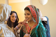 Dazzling Indian bride getting her jewelry on. Dazzling Indian bride getting her jewelry on.