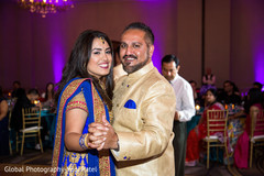 Indian couple dancing as guests observe Indian couple dancing as guests observe