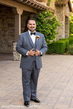 Indian groom posing for pictures outdoors prior to the ceremony Indian groom posing for pictures outdoors prior to the ceremony