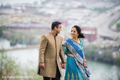 Joyful Indian couple hold hands as the photo shoot continues Joyful Indian couple hold hands as the photo shoot continues