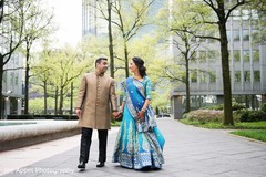 Indian bride and groom walk in the city during pictures Indian bride and groom walk in the city during pictures