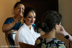Maharani being assisted with the bridal ornaments Maharani being assisted with the bridal ornaments