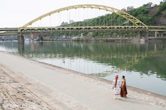 Amazing shot of the Indian couple walking next to the river Amazing shot of the Indian couple walking next to the river