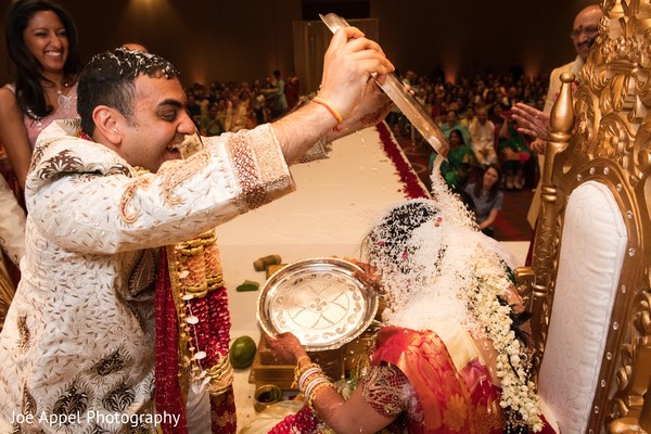 Groom pouring rice into the maharani during the ceremonies