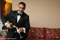 Indian groom pours some champagne prior to the ceremony Indian groom pours some champagne prior to the ceremony