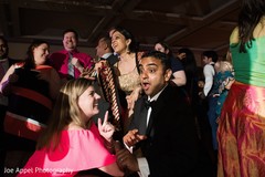 Indian groom having a blast with the guests at the Indian wedding reception Indian groom having a blast with the guests at the Indian wedding reception