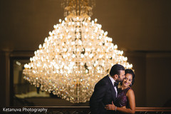 Indian couple having a tender moment by the chandelier Indian couple having a tender moment by the chandelier