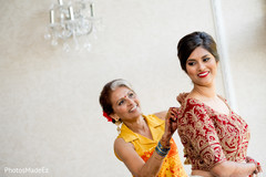 Indian bride putting her open shirt lehenga on. Indian bride putting her open shirt lehenga on.