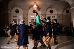 Joyful groomsmen lifting the Indian groom prior to the ceremonies Joyful groomsmen lifting the Indian groom prior to the ceremonies