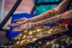 Indian bride getting mehndi art done Indian bride getting mehndi art done