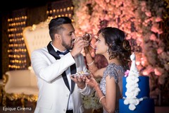 Indian newlyweds tasting their wedding cake Indian newlyweds tasting their wedding cake