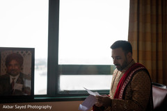 Indian groom focused reading a letter prior to the ceremony Indian groom focused reading a letter prior to the ceremony