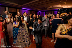 Fun capture of the guests enjoying the music at the reception Fun capture of the guests enjoying the music at the reception
