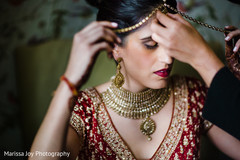 Indian bride wearing the traditional Tikka before the ceremony Indian bride wearing the traditional Tikka before the ceremony